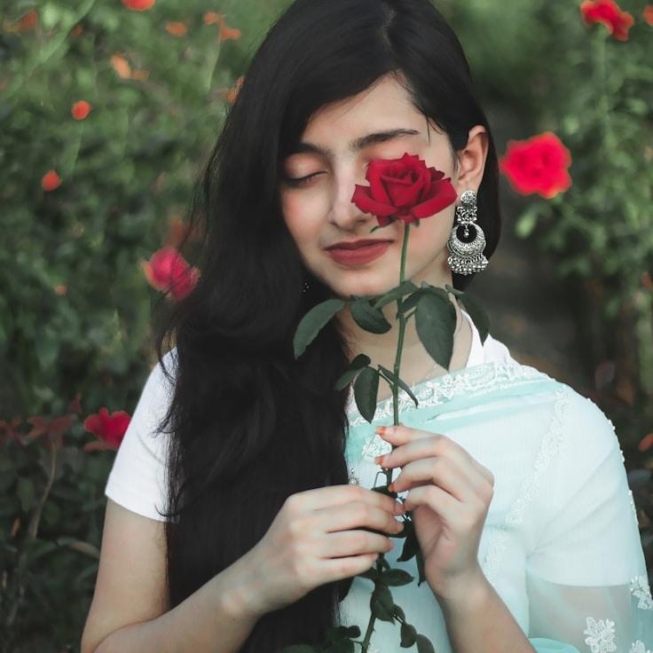 Ava Chen, Lead Design Curator at Quiet Field Nest, reviewing corporate floral arrangements